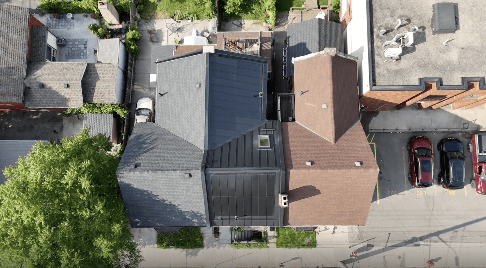 Top down view of a home with BIPV solar panels. These are integrated into the metal roof, and blend in seamlessly.