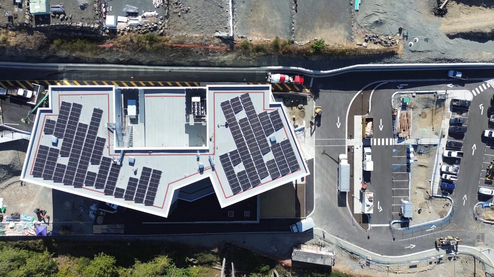 Aerial top-down view of a school with solar panels on the roof.
