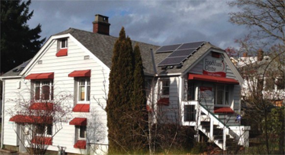 Side view of a community building with solar panels on the roof.